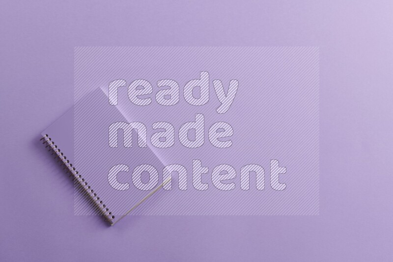 A purple notebook on purple background