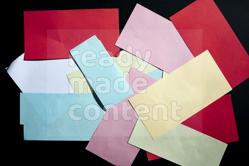 Multicolored paper sheet on black background