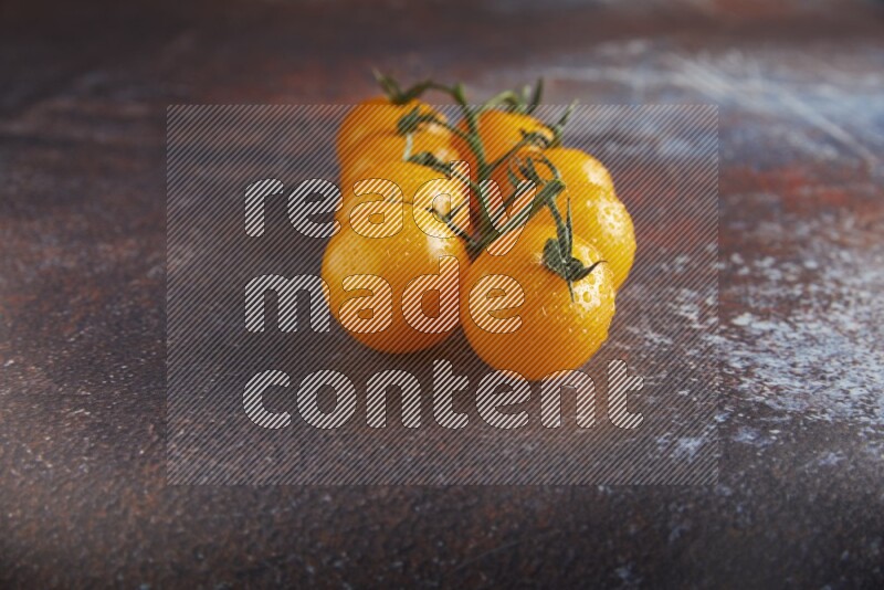 Yellow cherry tomato vein on reddish rustic metal background 45 degree