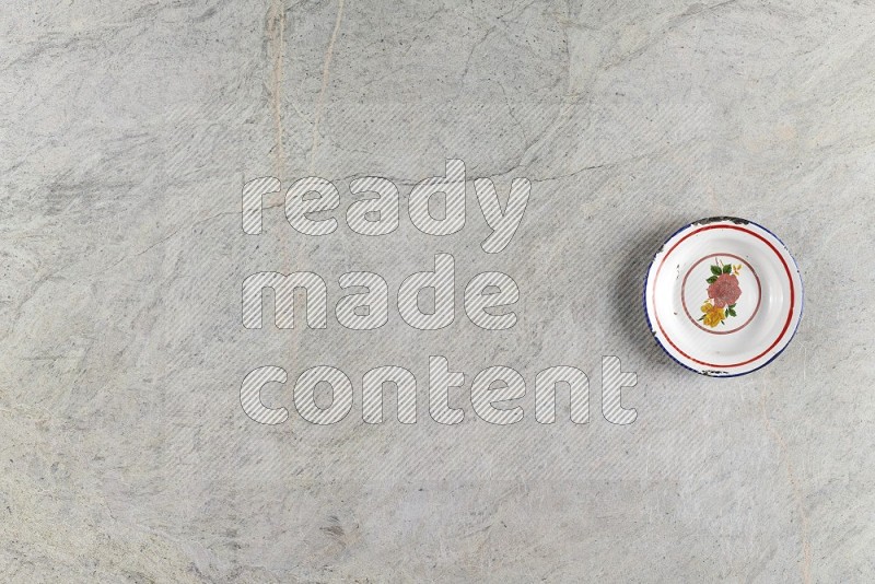 Top View Shot Of A Vintage Metal Plate On Grey Marble Flooring