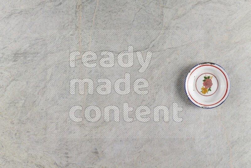 A vintage metal plate on grey marble background