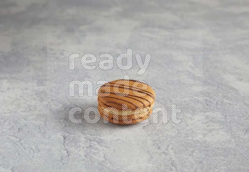 45º Shot of light brown  Almond Cream macaron on white  marble background