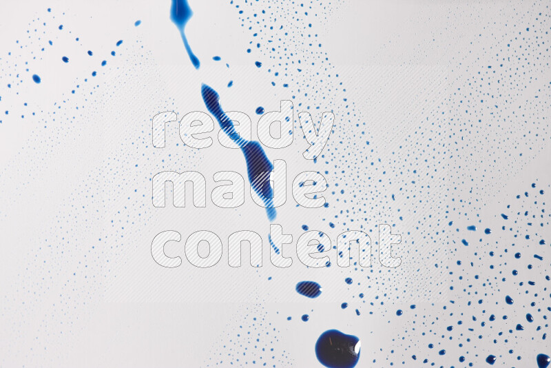 Close-ups of abstract blue paint droplets on the surface