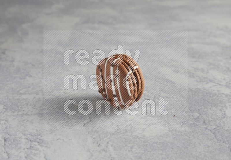 45º Shot of Brown white Chocolate Caramel macaron on white  marble background