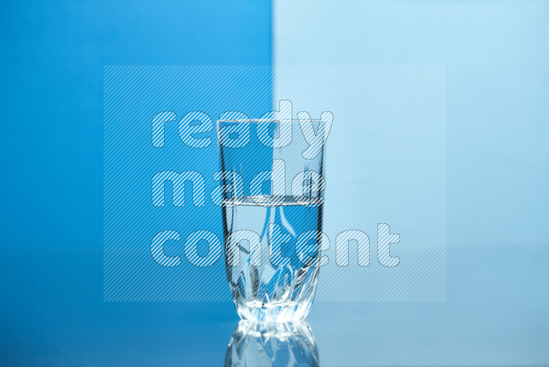 The image features a clear glassware filled with water, set against blue and light blue background