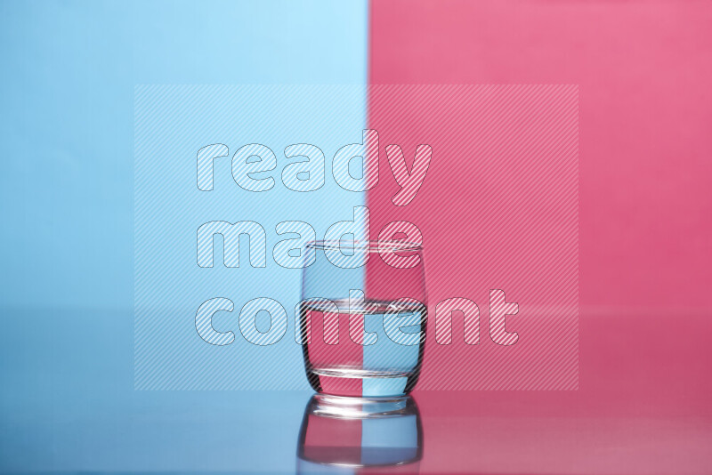 The image features a clear glassware filled with water, set against light blue and pink background