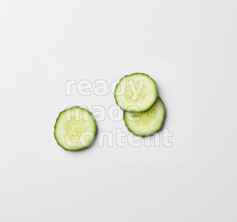three cucumber slices on white background