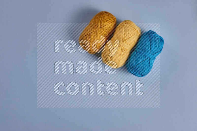 A yellow and blue collection of sewing and tailoring tools arranged on a blue background