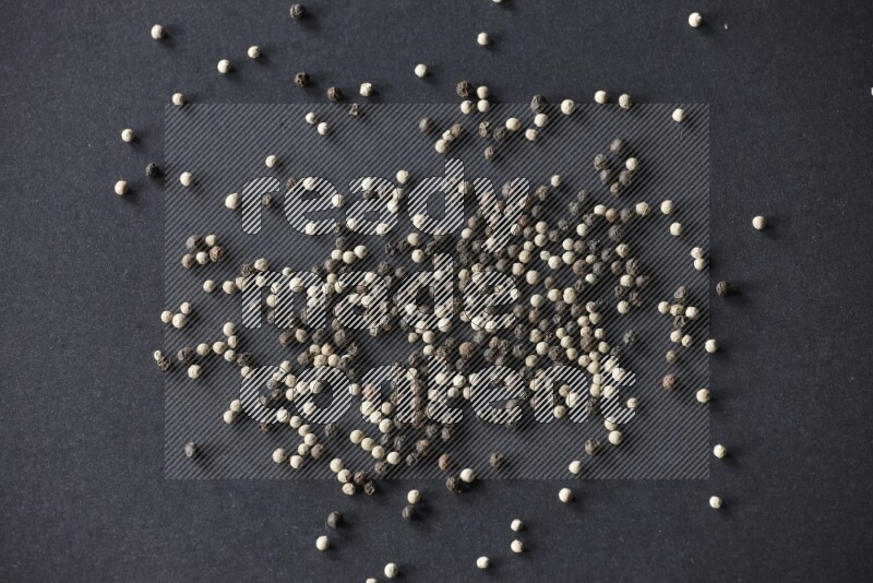 Mixed black and white pepper beads on a black flooring