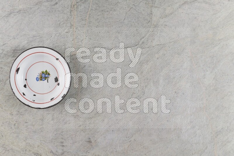 A vintage metal plate on grey marble background