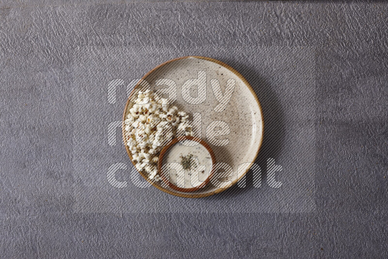 Assorted snacks in pottery bowls on grey background