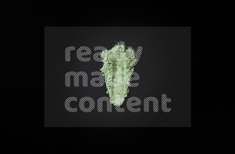 Green powder strokes on black background