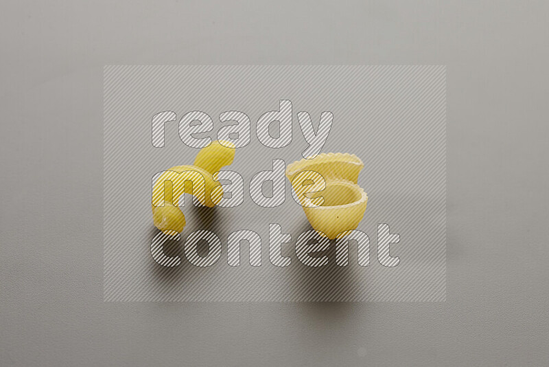 Twist pasta with other types of pasta on grey background