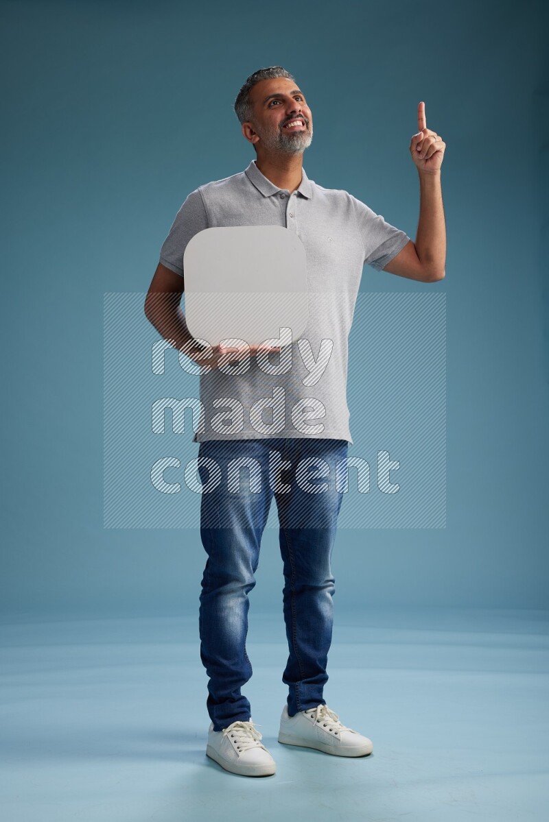 Man Standing holding social media sign on blue background