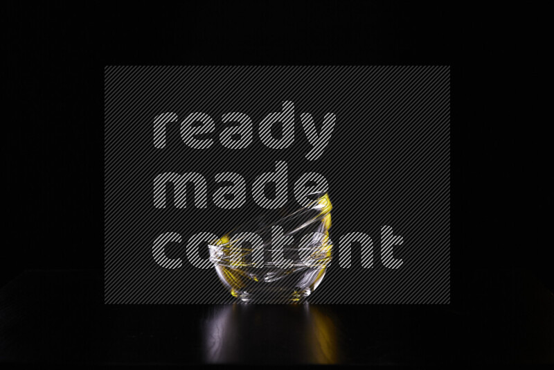 Glassware with rim light in yellow and white against black background