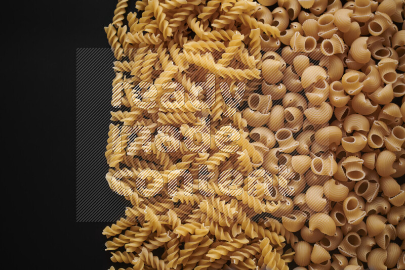 Different pasta types on black background