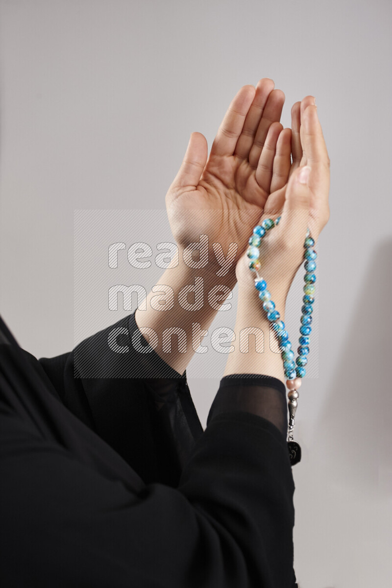 Woman hands holding praying beads (sebha) in different positions