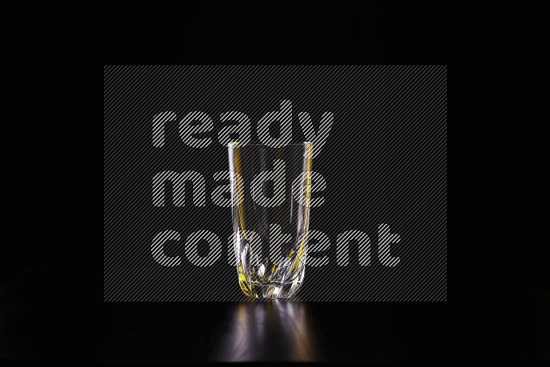 Glassware with rim light in yellow and white against black background