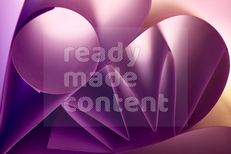 An artistic display of paper folds creating a harmonious blend of geometric shapes, highlighted by soft lighting in purple tones