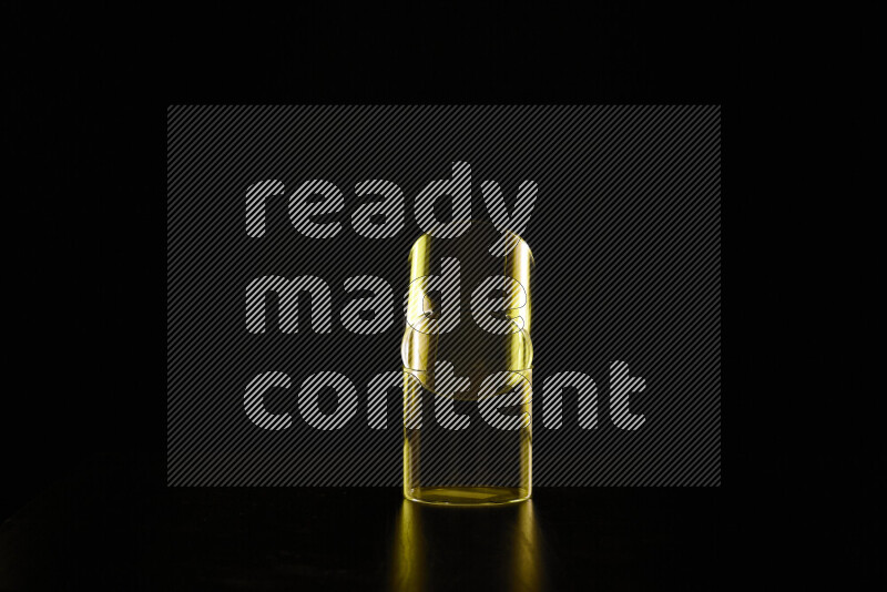 Glassware with rim light in yellow against black background