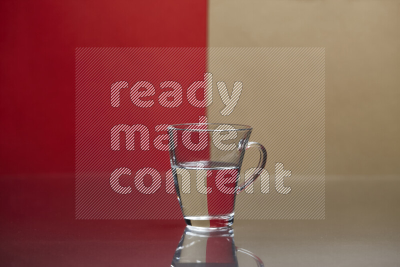 The image features a clear glassware filled with water, set against red and beige background