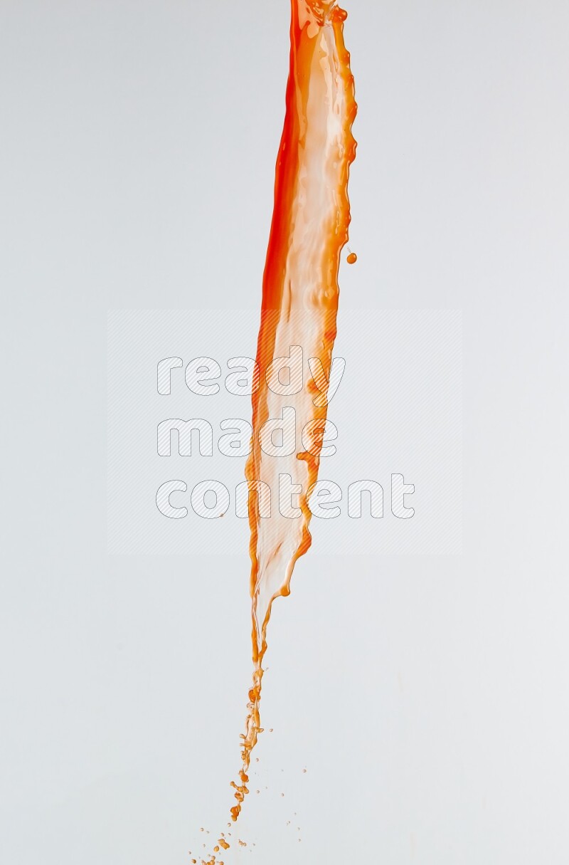 Orange liquid splash and drops on white background