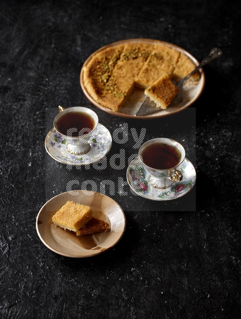 konafa with tea in a dark setup