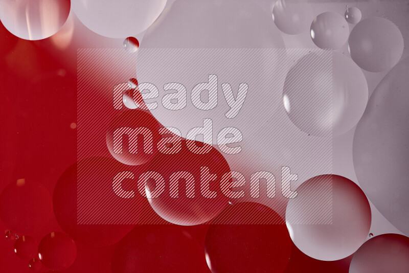 Close-ups of abstract oil bubbles on water surface in shades of white and red