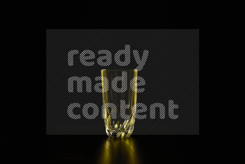 Glassware with rim light in yellow against black background