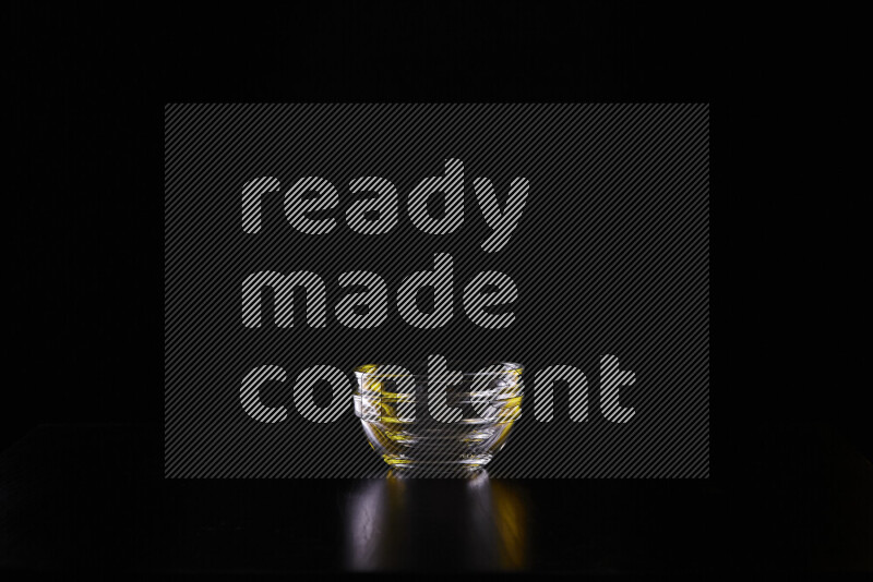 Glassware with rim light in yellow and white against black background