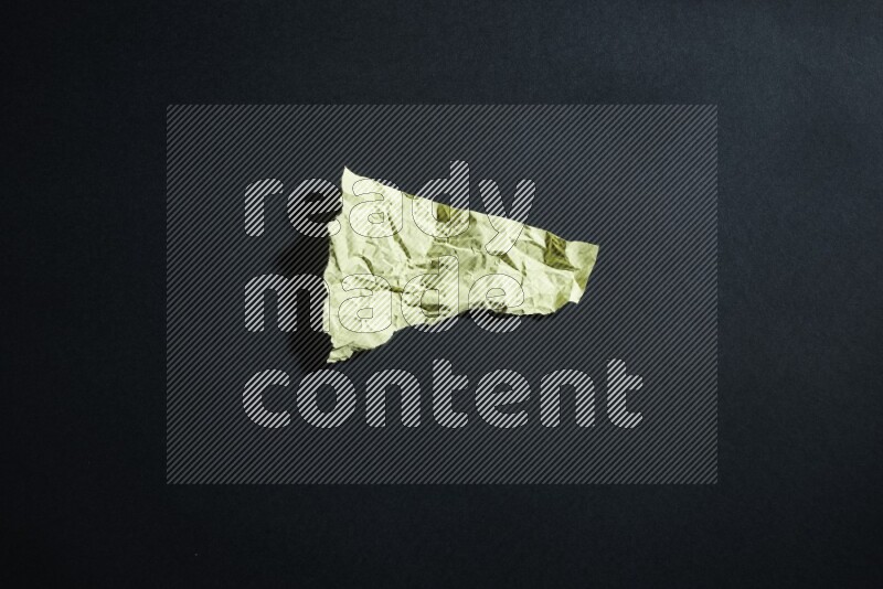 Yellow paper sheet on black background