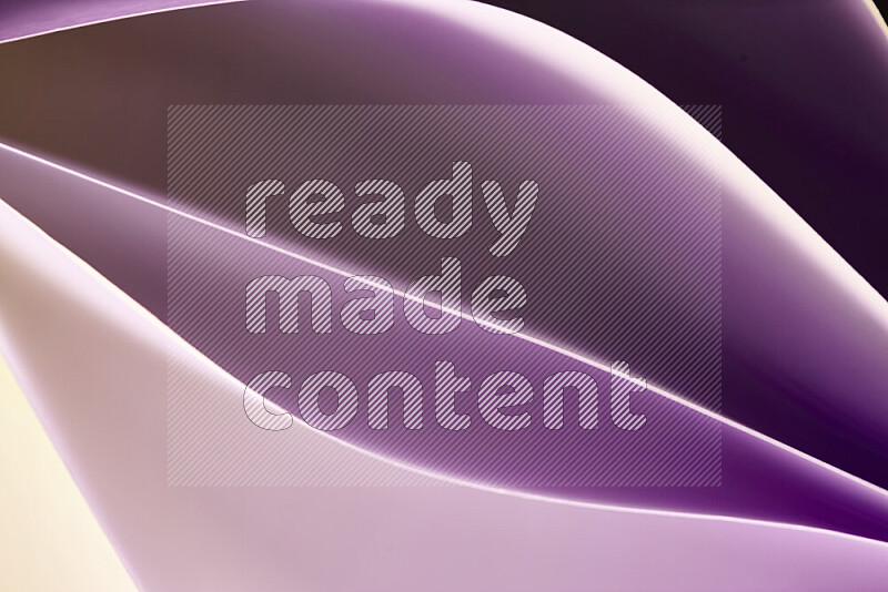 This image showcases an abstract paper art composition with paper curves in purple and gold gradients created by colored light