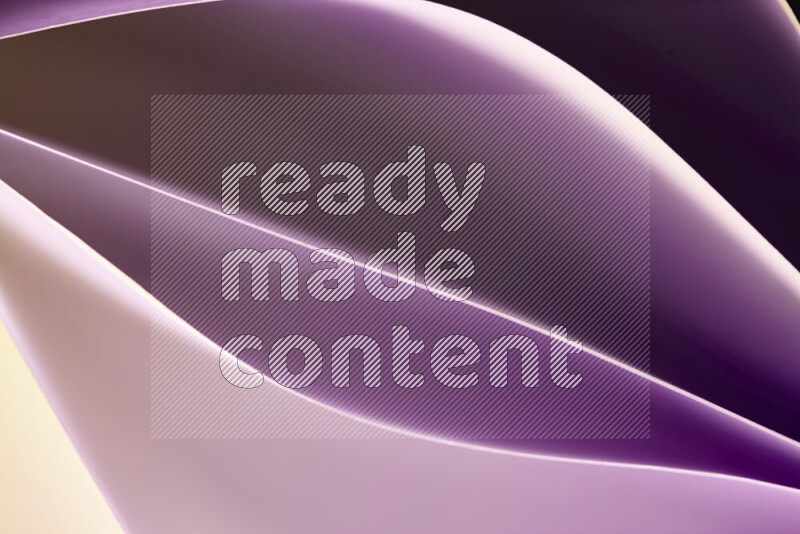 This image showcases an abstract paper art composition with paper curves in purple and gold gradients created by colored light