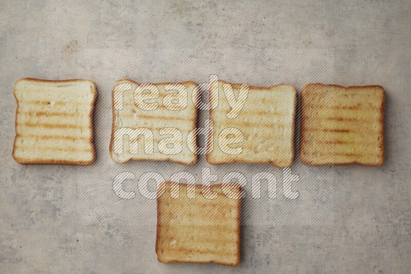 Toasted white Toast slices on a light blue textured background