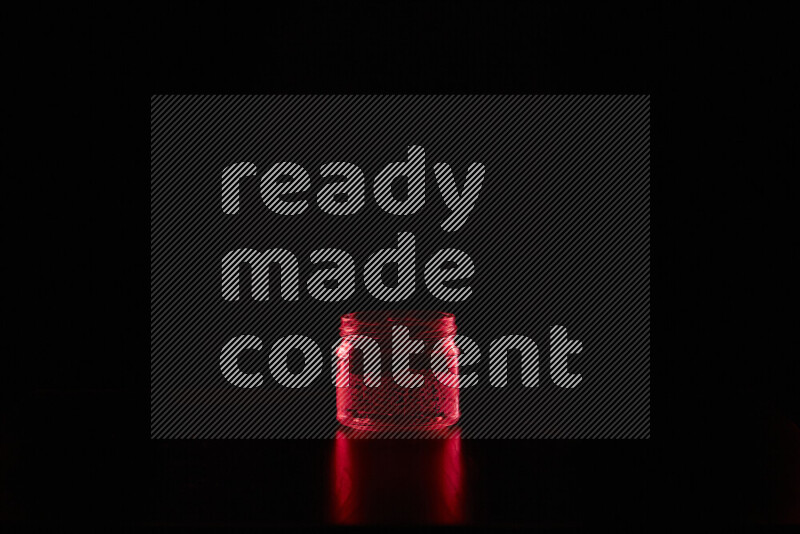 Glassware with rim light in red against black background