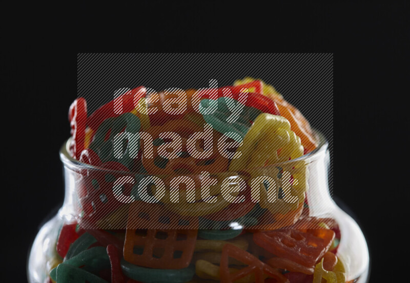 Snacks in a glass jar on black background
