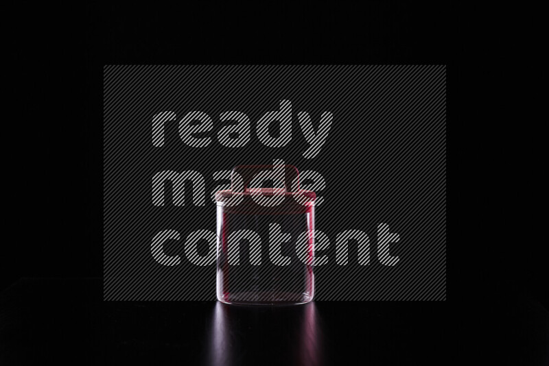 Glassware with rim light in red and white against black background