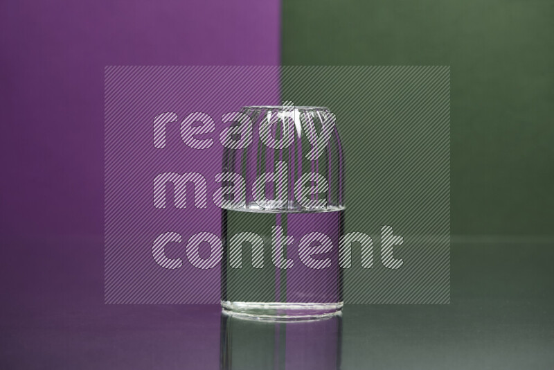 The image features a clear glassware filled with water, set against purple and dark green background