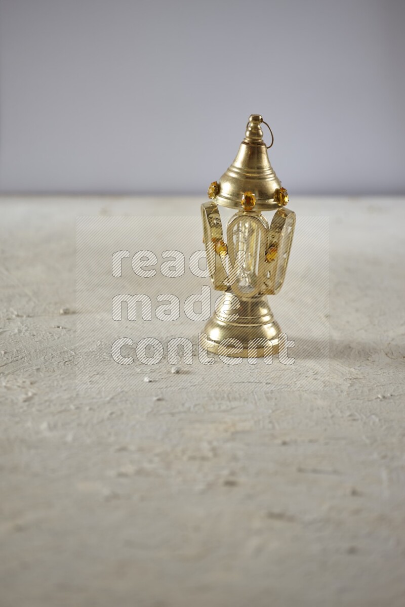 A lantern placed on a textured white background