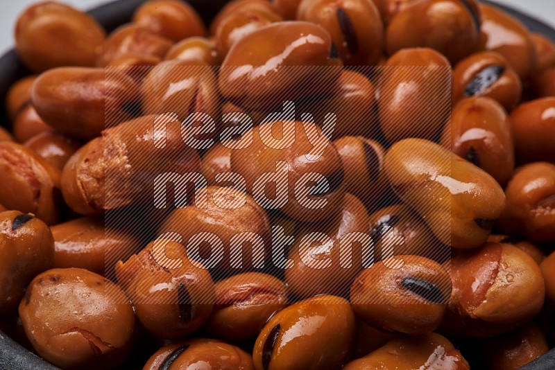 Close up shot of cooked fava beans (foul) on white background