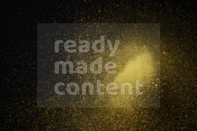 Yellow powder explosion on black background