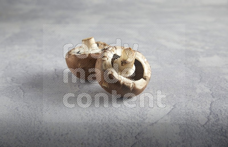 45 degre cremini  mushrooms on a textured light blue background