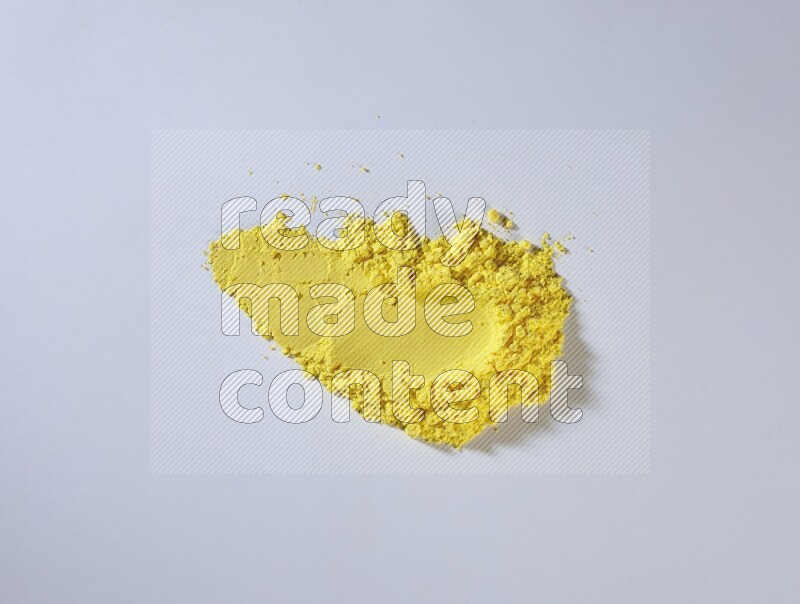 Yellow powder strokes on white background