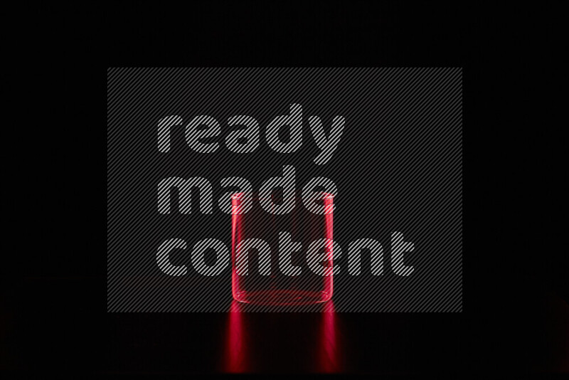 Glassware with rim light in red against black background