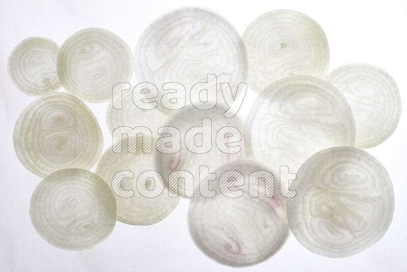 Onion slices on illuminated white background