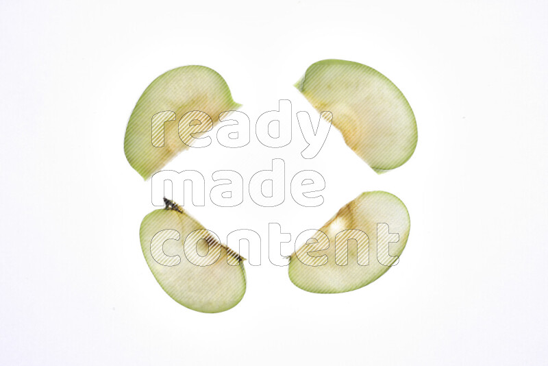 Apple slices on illuminated white background