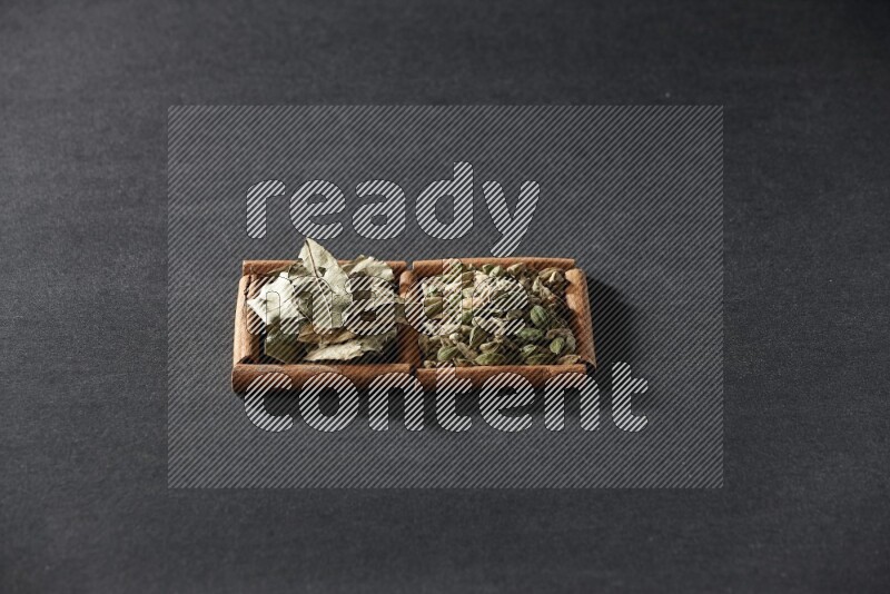 2 squares of cinnamon sticks full of cardamom and bay laurel leaves on black flooring