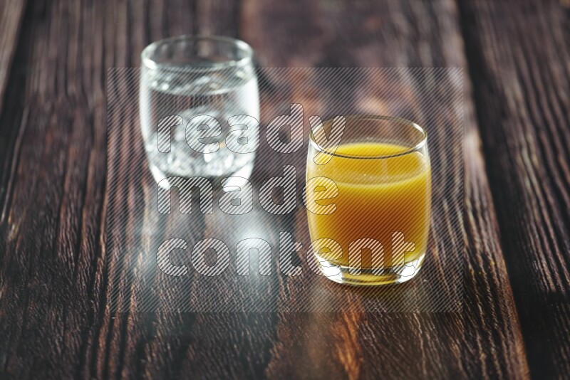 Cold drinks in a glass cup such as water, tamarind, qamar eldin, sobia, milk and hibiscus on wooden background