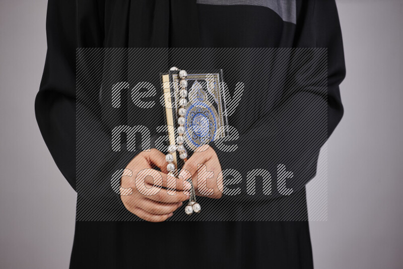 A woman hands holding moshaf in different positions