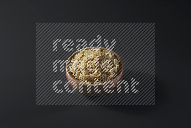 Snacks in a wooden bowl on grey background